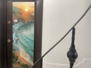 A door with a scenic ocean view, a number '200' sticker, and a list of room rules. - ivy hostel (Istanbul)