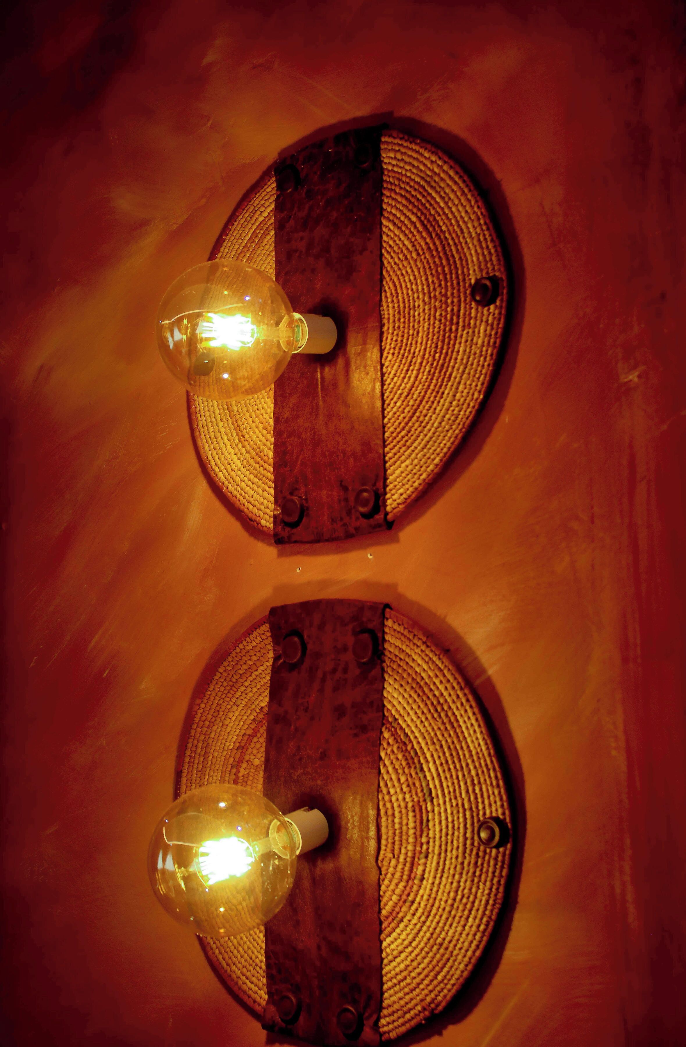 Two wall-mounted light fixtures with clear glass covers and wooden accents.