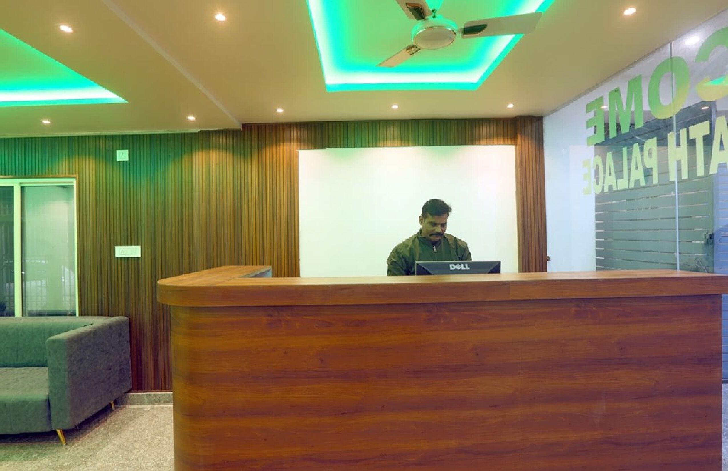 A reception desk with a person behind it, a wooden counter, and a sign that reads "COMMERCE HOTEL".