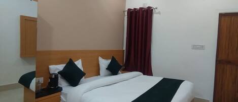 A neatly arranged bedroom with a bed, a bedside table, a mirror, and a ceiling fan.