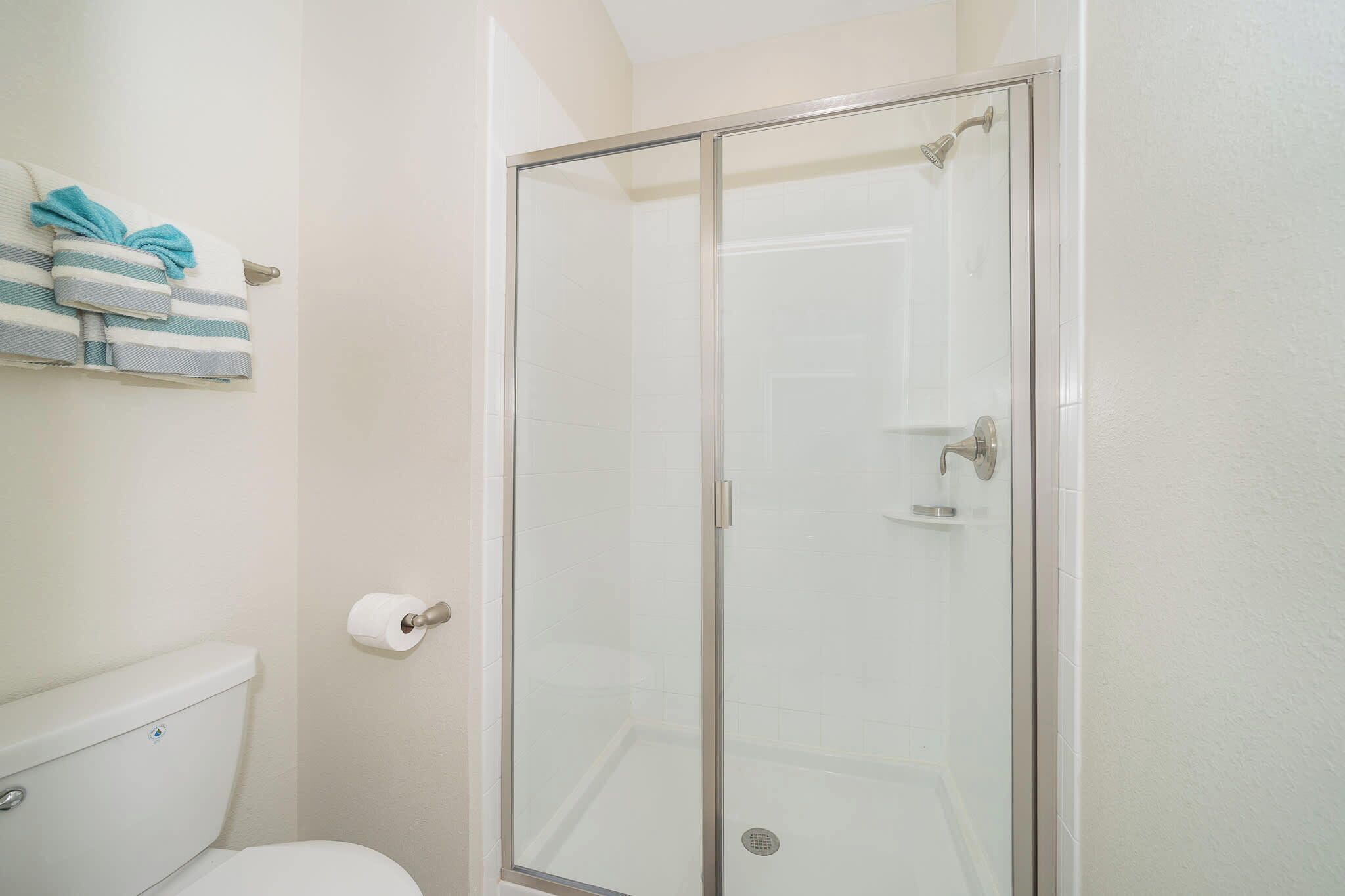 Shower, hair dryer, towels, shampoo