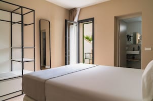 One-Bedroom Suite with balcony | Desk, laptop workspace, blackout drapes, iron/ironing board