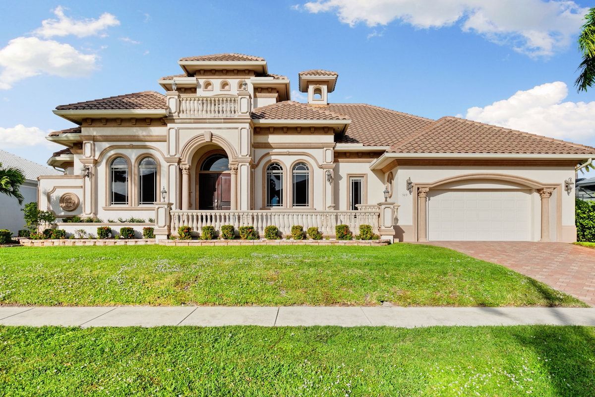 A large, single-story house with a tiled roof, a front porch, and a garage.