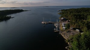 A marina with boats docked, surrounded by forested land.