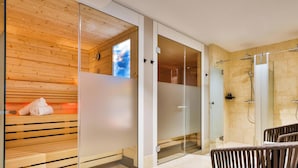 A modern bathroom with a glass shower enclosure, wooden paneling, and a visible temperature control. - Dünenloft, House Kliff Whg. 11 (Sylt)