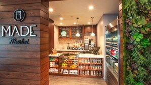 A cozy market with wooden walls, a coffee station, and a variety of food items. - Sunny Oasis | Swimming. Restaurant (Hollywood)