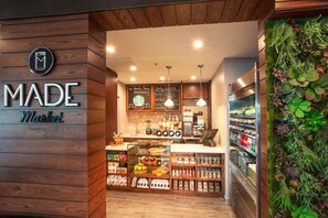 A cozy market with wooden walls, a coffee station, and a variety of food items. - Sunny Oasis | Swimming. Restaurant (Hollywood)