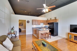 A modern apartment with a kitchen, dining area, and living room.