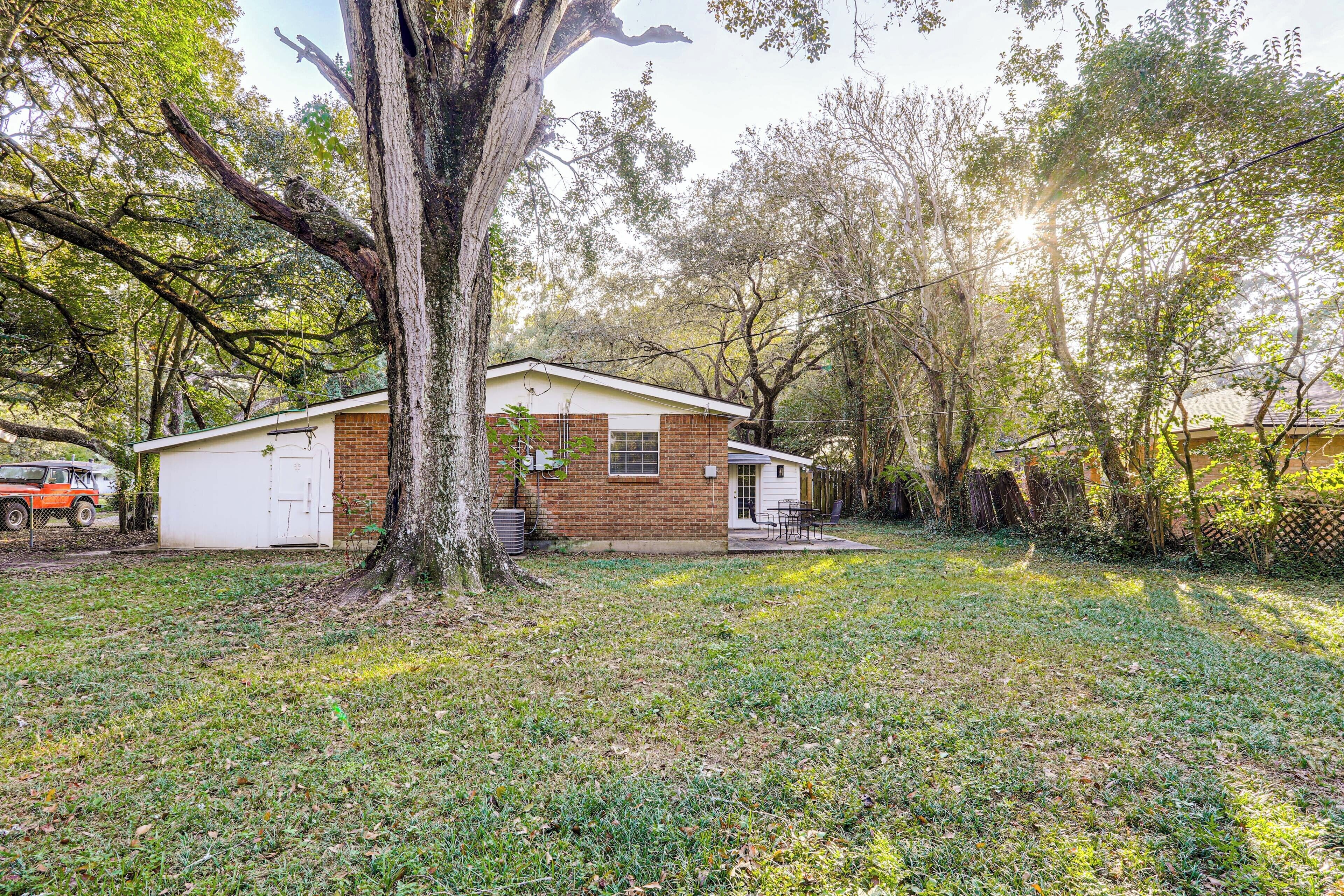 A single-story house with a brick exterior, a white garage door, and a small porch.