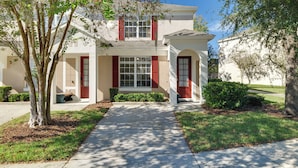 A two-story house with a front entrance, a covered porch, and a driveway. - 5 Mi to Disney Parks: Family Home w/ Resort Perks! (Kissimmee)