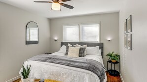 A bedroom with a bed, bedside tables, a ceiling fan, and a window with blinds. - 2 Blocks to At&t Stadium: Sports Fan Headquarters! (Arlington)