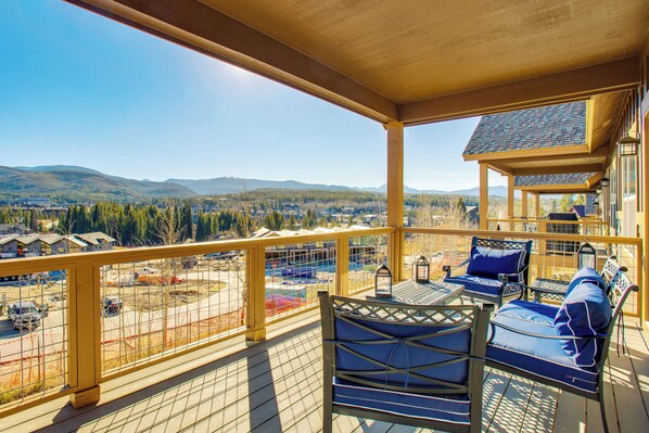 A wooden deck with outdoor seating and a view of a mountainous landscape. - < 5 Mi to Winter Park: Family Base Camp w/ Hot Tub (Fraser)