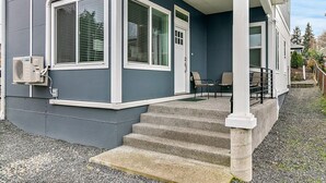 A two-story house with a covered porch, a front door, and a small set of steps leading to the entrance. - 2 Bed MIL unit with Lake Washington views (Seattle)