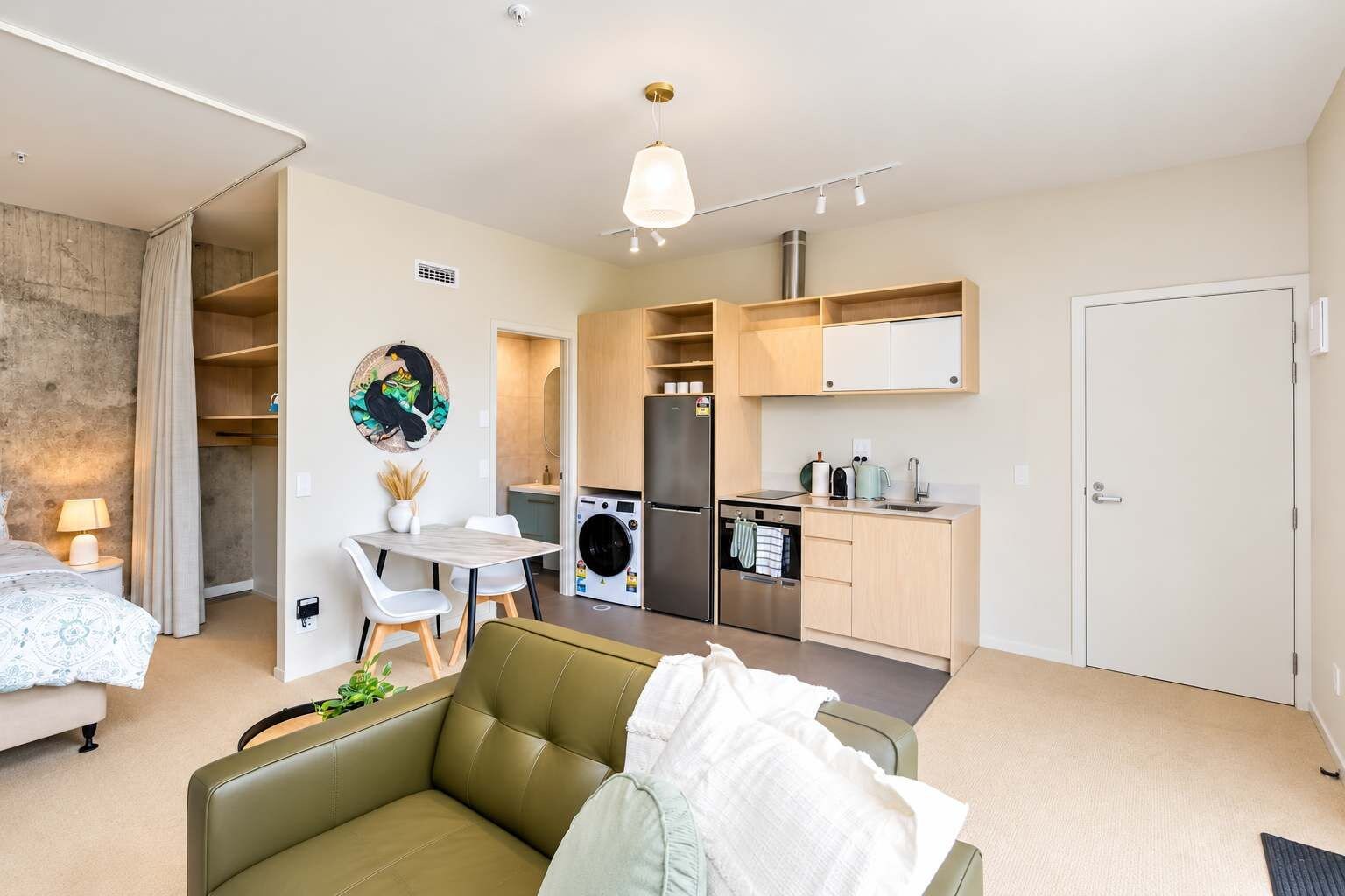 A compact living space with a kitchenette, a dining area, and a seating area.