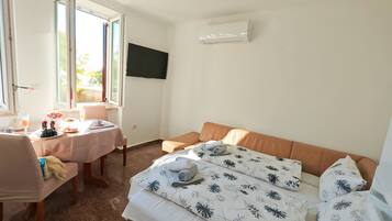 Classic Apartment, Patio, Garden View | Living area | 70-inch Smart TV with satellite channels