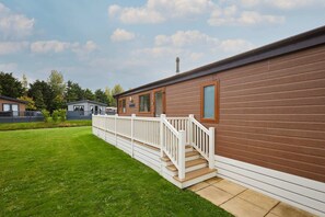 A single-story wooden house with a white porch and a small set of stairs leading to a door. - Host Stay Kinship Lodge (York)