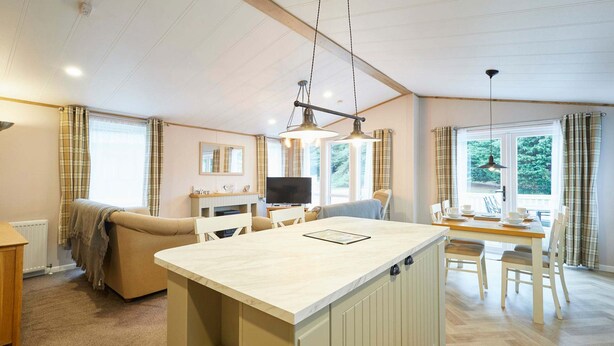 A spacious living area with a kitchen island, dining table, and seating. - Host Stay Hawthorne Villa (York)
