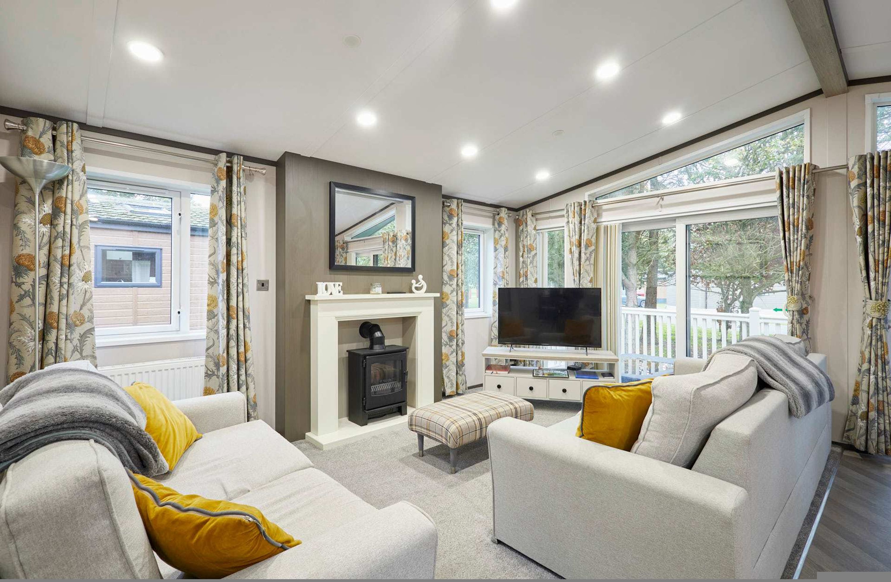 A living room with a fireplace, sofa, and TV.