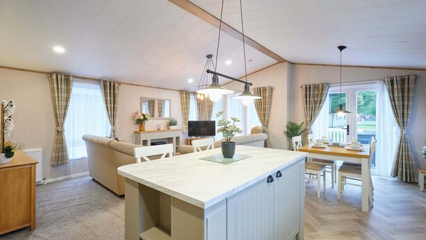 A spacious living area with a central island, a dining table, and a sofa. - Host Stay Barakah Lodge (York)