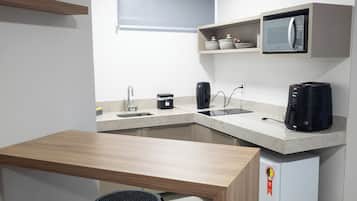 Mini-fridge, microwave, stovetop, cookware/dishes/utensils