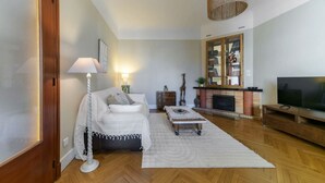 Ein modernes Wohnzimmer mit einer Couch, einem Couchtisch, einem Fernseher und einem Kamin.