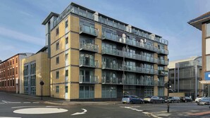 A multi-story building with a modern architectural design, featuring balconies and large windows. - Charming Central Studio with Balcony in Birmingham (West Midlands)