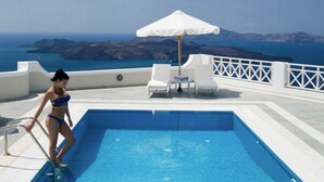 A pool with a view of the sea, a white umbrella, and lounge chairs. - Endearing Santorini Villa | Villa Delphi | 2 Bedrooms | Breathtaking Caldera. (Santorini)