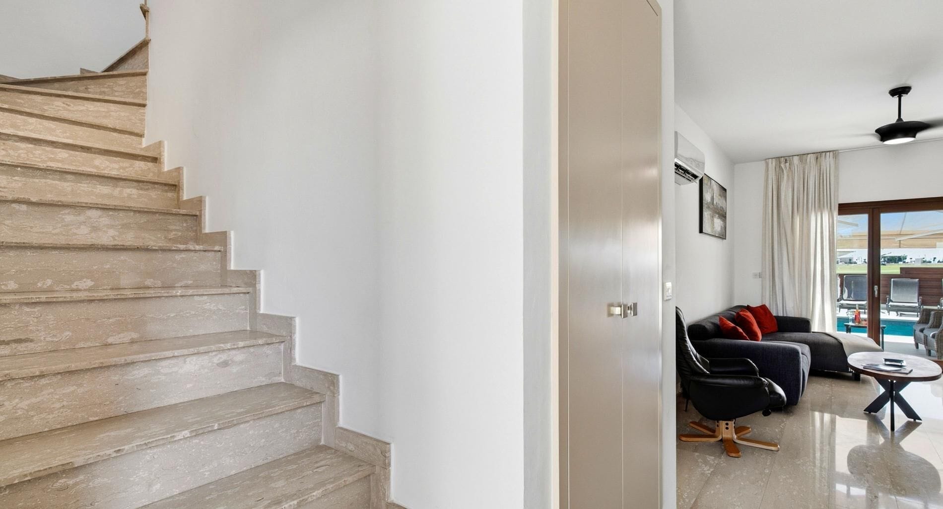 A staircase leading to a living area with a sofa and a coffee table.