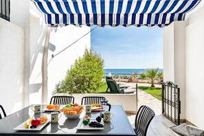A table set with food and drinks, overlooking a garden and the sea. - Beachfront holiday home in Malaga (Malaga)