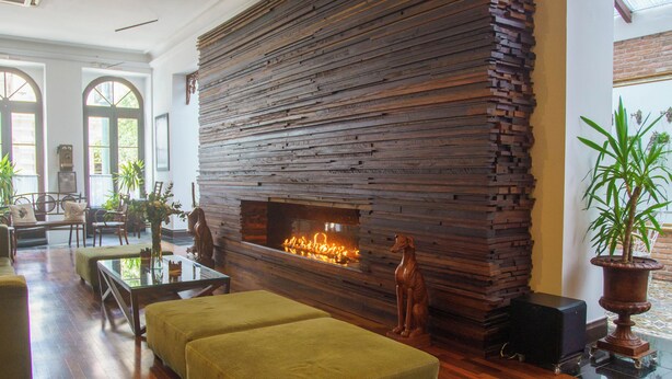 A spacious living area with a large stone fireplace, wooden flooring, and comfortable seating. - Celebrate Love in Style—Bridal Suite with Breakfast Buffet in Curitiba’s Spot (State of Paraná)