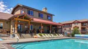 A hotel with a swimming pool, a covered patio, and a staircase leading to the entrance. - Peak Location Near Slopes & Olympic Park (Park City)