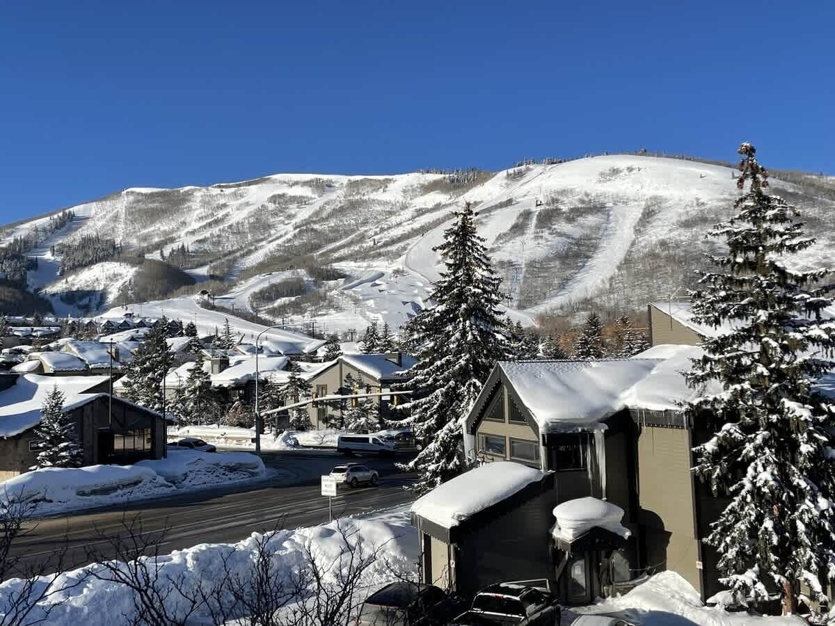 A snow-covered mountain town with buildings and a road.