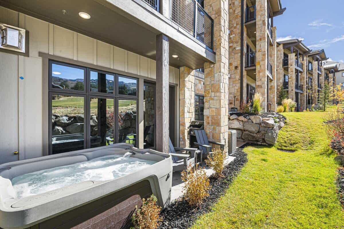 The patio windows reflect the golf course and mountain views