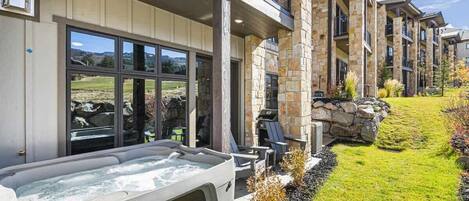 The patio windows reflect the golf course and mountain views