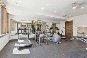 A gym with treadmills, elliptical machines, and a bench. - Canyons Mountain Views - Private Hot Tub, Golf (Park City)