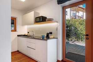 A compact kitchen with a microwave, coffee maker, and a small sink. - Studio Apartment 'Lara Ruveda 2' with Mountain View, Private Terrace & Wi-Fi (Sankt Ulrich)