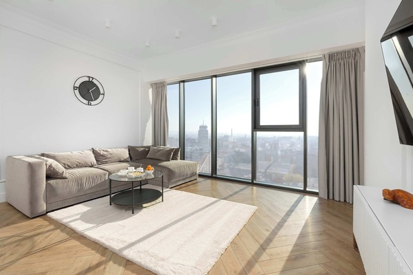 Living area with large windows overlooking the city skyline.