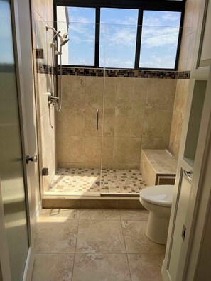 A bathroom with a shower, toilet, and a window. - 3-bedroom townhome in fabulous Longboat Key with stunning views and boat dock (Longboat Key)