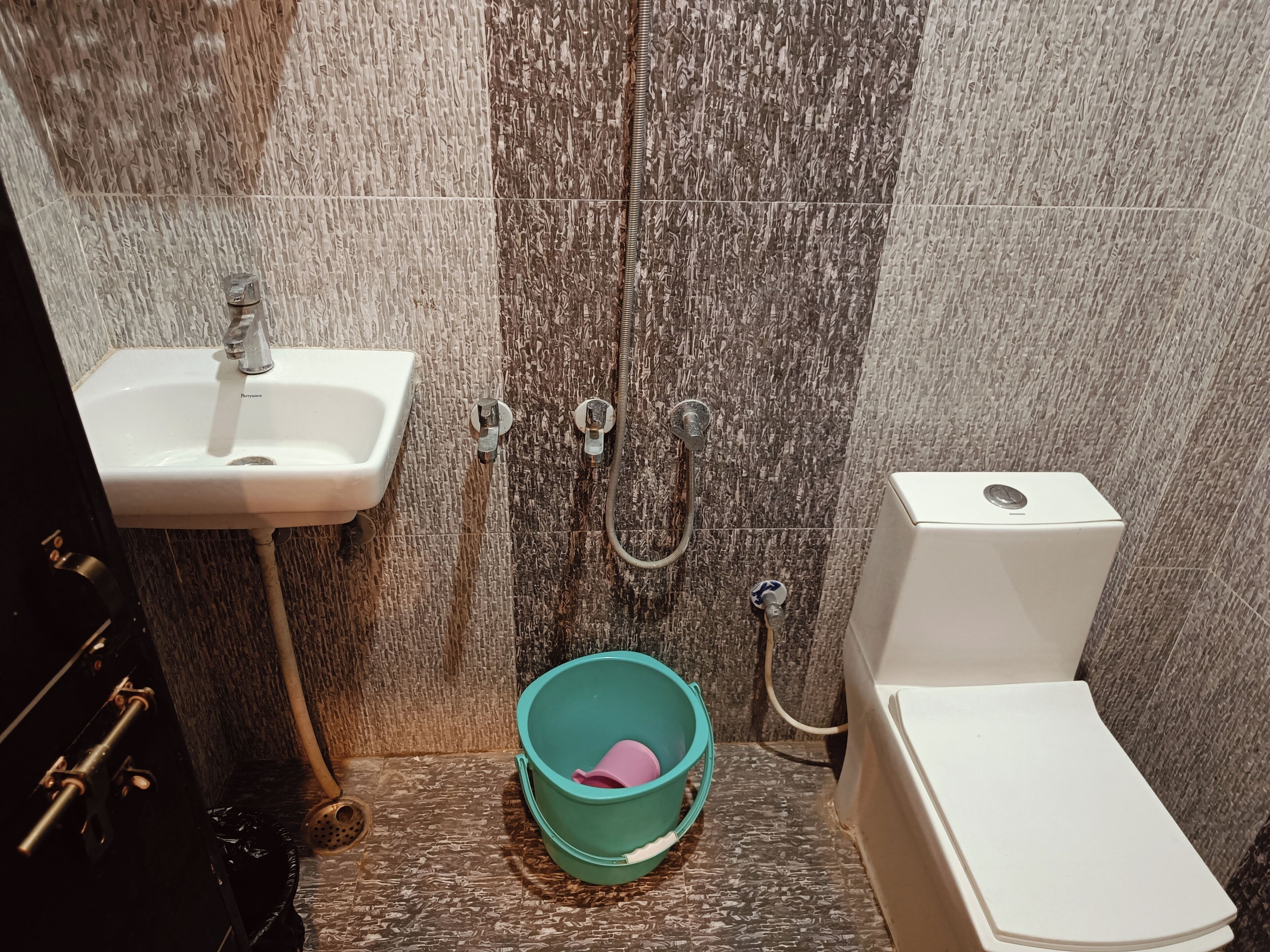 A bathroom with a sink, toilet, and shower.