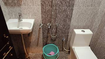 A bathroom with a sink, toilet, and shower.