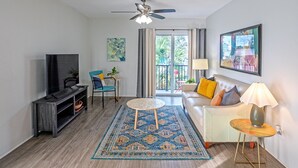 A living room with a TV, sofa, and a ceiling fan. - 2BR • 4 Beds • by Miami SoFi Vacation Rentals <br>Tucked in a quiet Palmetto Bay neighborhood, this property offers stylish 2BR/1BA stays with thoughtful design, outdoor spaces, and easy access to parks, dining, and Miami hotspots. (Palmetto Bay)