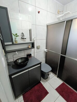 Shower, hair dryer, towels, toilet paper