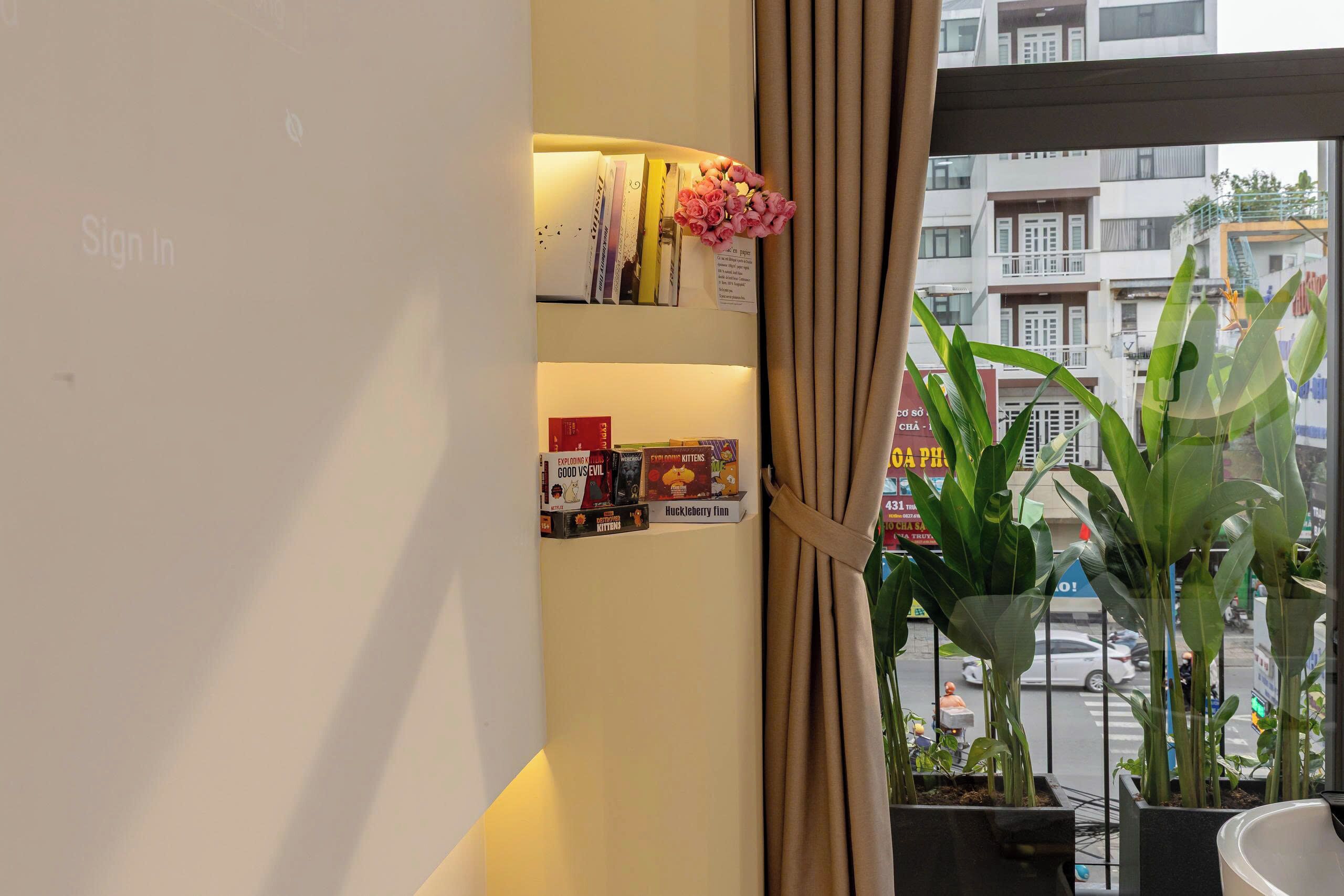 A bookshelf with books and a sign-in area.