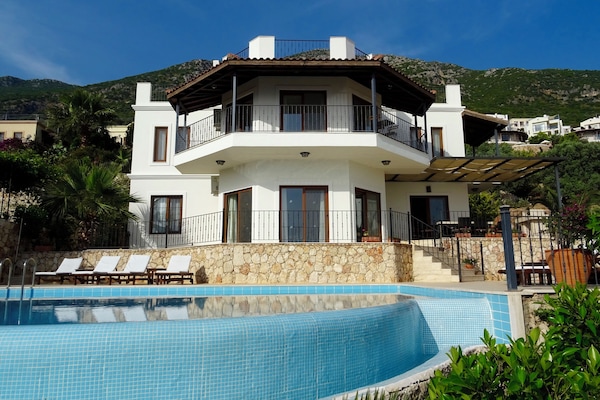 Villa Nazli from the lower garden, with fruit trees and stunning bougainvillea