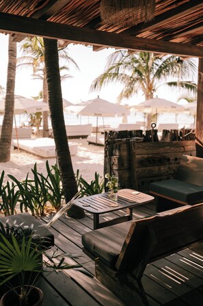 Terrace/patio - Wake up to turquoise waters at Isla Bliss 🌴 — a luxury 3-bedroom oceanfront condo just minutes from Isla Mujeres’ best dining and beaches. Enjoy a 90" Smart TV, stunning views, fast WiFi, and easy self-check-in for the perfect island escape. 🌊✨ (Isla Mujeres)