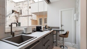 Eine moderne Küche mit Spüle, Arbeitsplatte und Barhocker.