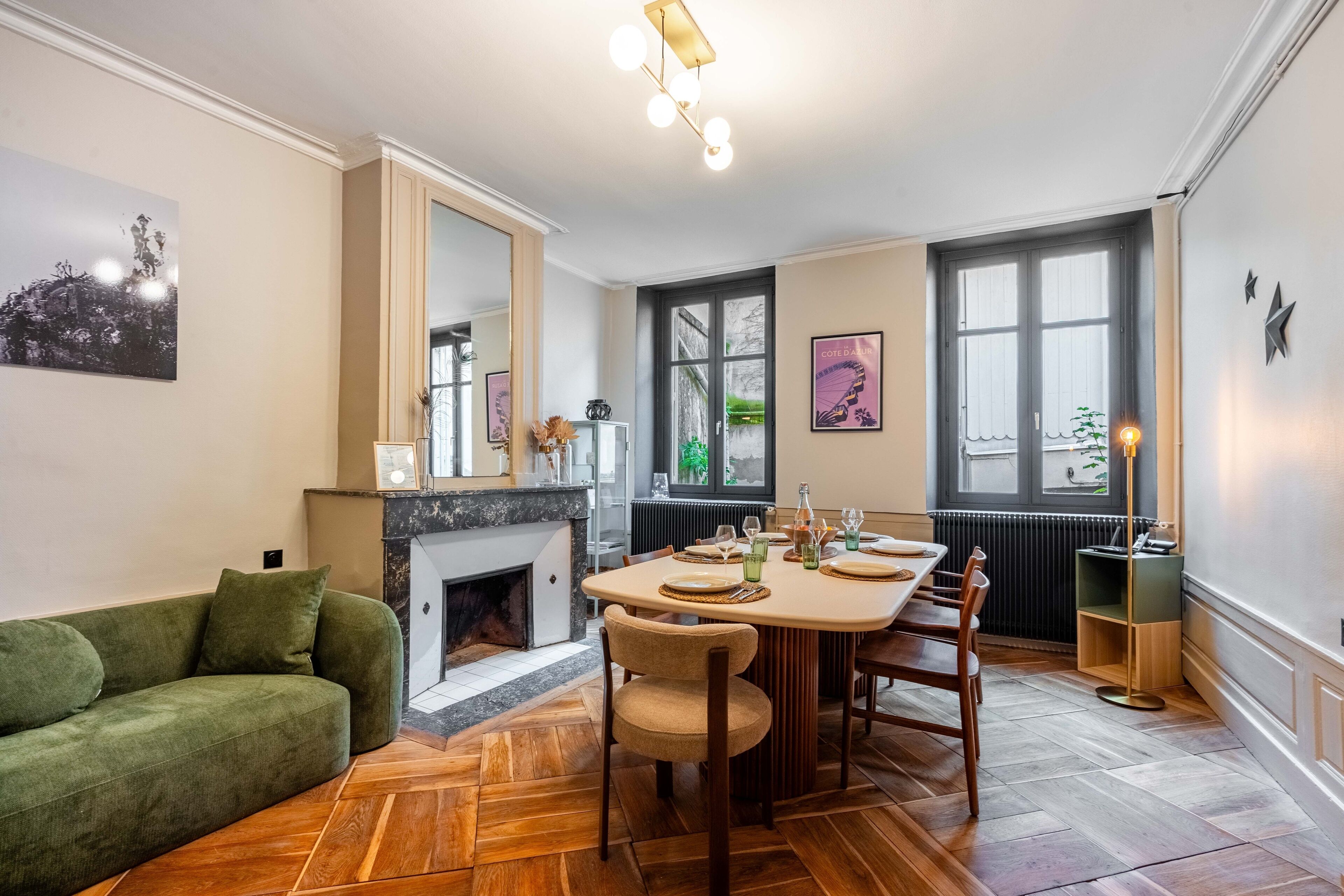 A dining area with a wooden table, chairs, and a fireplace.