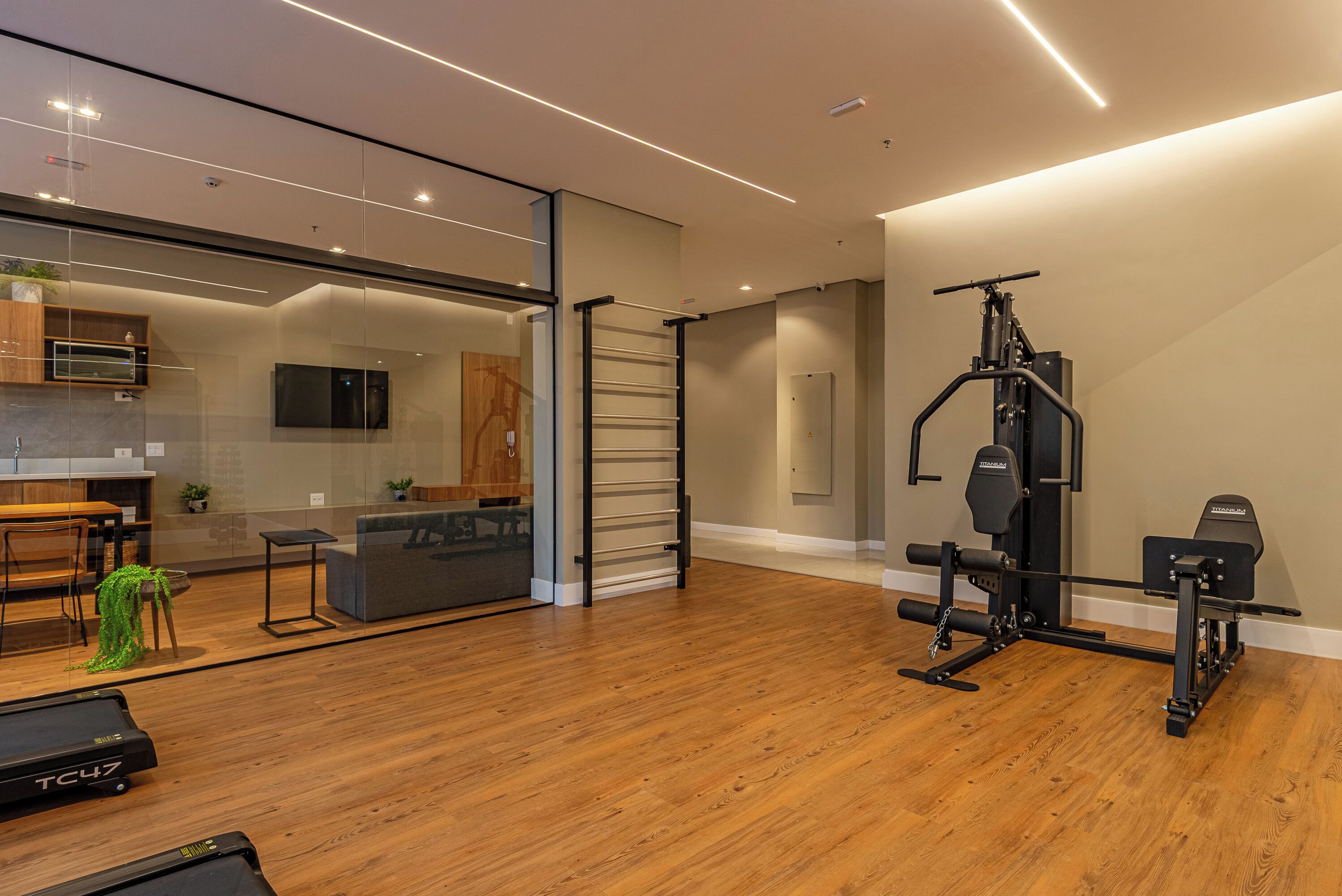 A modern home gym with a treadmill, weight bench, and exercise equipment.
