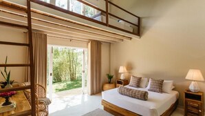 A modern bedroom with a large bed, a wooden desk, and a balcony. - Rukgala Retreat (Digana, Kandy)