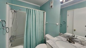 A bathroom with a bathtub, shower, toilet, and sink. - Pam's Paradise (Carolina Beach)